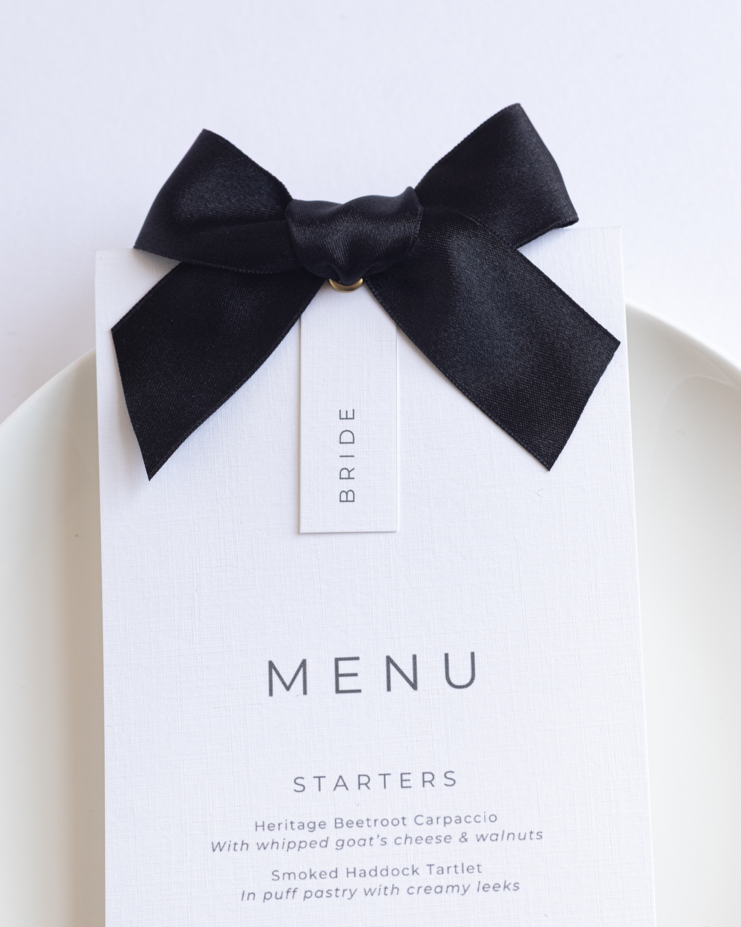 Wedding Menu card with a black bow on a white background