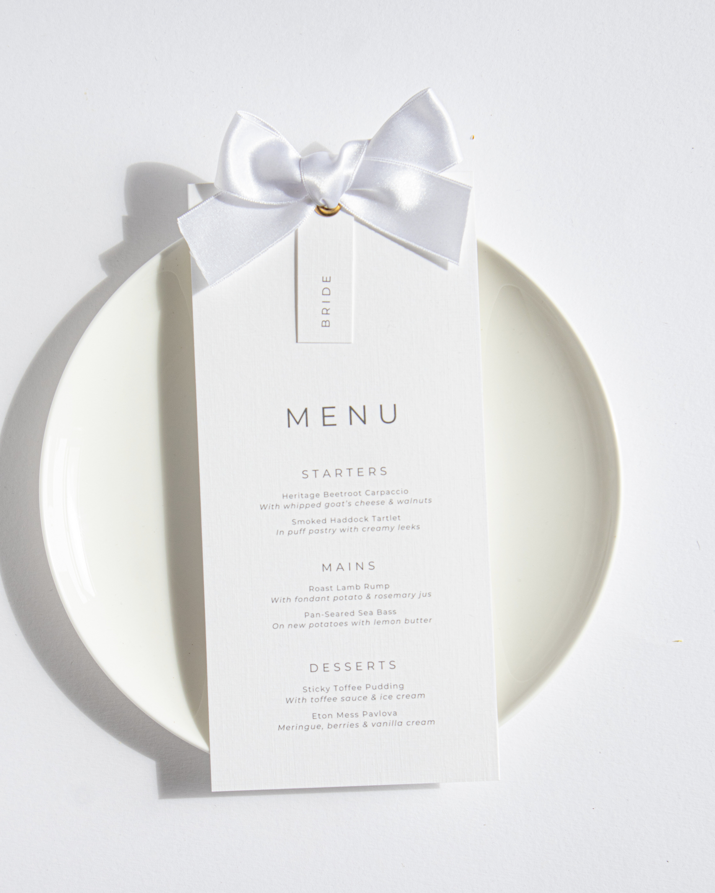 Wedding menu card with a white bow on a white background