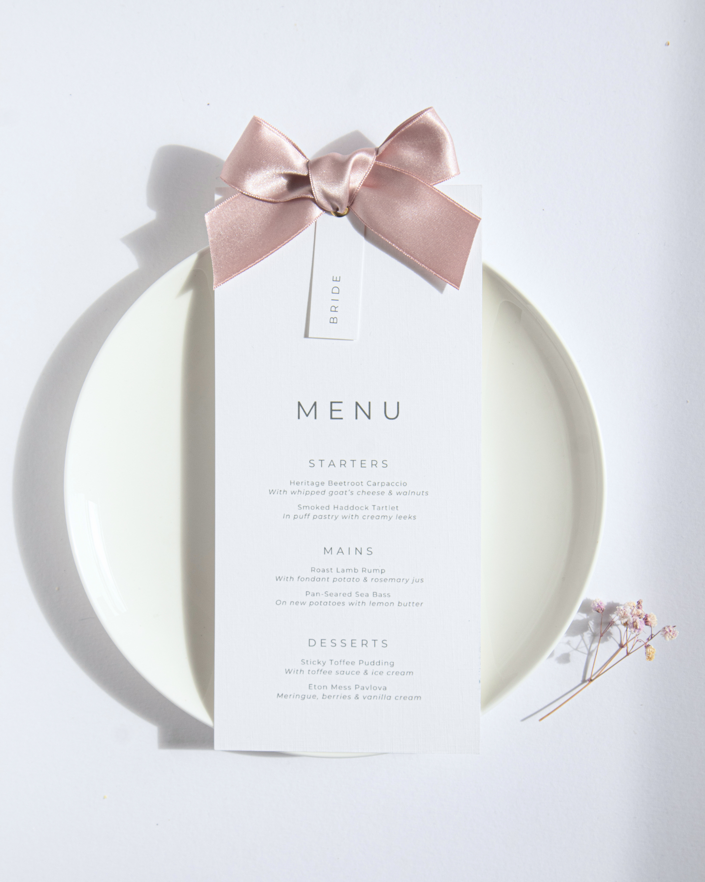 Menu card with a pink bow on a white background